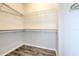 Walk-in closet with wire shelving and wood-look flooring at 7570 Tamarind Ave, Tampa, FL 33625