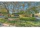 Landscaped entrance to Village Centre with mature trees and well-maintained grounds at 7570 Tamarind Ave, Tampa, FL 33625