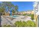 Community pool area with lounge chairs, umbrellas, and clubhouse in a residential setting at 7570 Tamarind Ave, Tampa, FL 33625