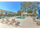 Relaxing community pool with ample seating, umbrellas, and views of the surrounding homes at 7570 Tamarind Ave, Tampa, FL 33625