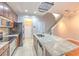 Kitchen with stainless steel appliances and a large kitchen island with light granite countertop at 7570 Tamarind Ave, Tampa, FL 33625