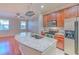 Kitchen with stainless steel appliances and a kitchen island with light granite countertop at 7570 Tamarind Ave, Tampa, FL 33625