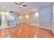 Open concept living space featuring hardwood floors, staircase, and kitchen counter at 7570 Tamarind Ave, Tampa, FL 33625
