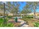 Serene park area in the neighborhood with benches, lush greenery, and walking paths at 7570 Tamarind Ave, Tampa, FL 33625
