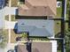 Birds eye view of single-Gathering home with a gray roof, lawn and nearby properties at 8133 Canterbury Lake Blvd, Tampa, FL 33619
