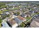 Community aerial view showcasing a neighborhood with a lake, ponds, and well-maintained homes at 8133 Canterbury Lake Blvd, Tampa, FL 33619