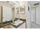 A well-lit bathroom featuring a spacious vanity, ample lighting, and tile flooring at 8133 Canterbury Lake Blvd, Tampa, FL 33619