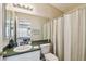 Cozy bathroom featuring a vanity with sink, commode, and a shower with curtain at 8133 Canterbury Lake Blvd, Tampa, FL 33619