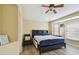 Comfortable bedroom with wood look floors, ceiling fan, and plenty of natural light at 8133 Canterbury Lake Blvd, Tampa, FL 33619