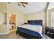 Comfortable bedroom featuring wood look floors, ceiling fan, and ensuite bath at 8133 Canterbury Lake Blvd, Tampa, FL 33619