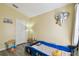 Cozy bedroom with blue car-shaped bed, elephant decor, and a window that lets in natural light at 8133 Canterbury Lake Blvd, Tampa, FL 33619