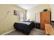 This bedroom has a bed with a blue comforter, wooden furniture, and wood floors at 8133 Canterbury Lake Blvd, Tampa, FL 33619