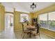 Dining area featuring a glass round table, chandelier, and a pass-through to the kitchen at 8133 Canterbury Lake Blvd, Tampa, FL 33619
