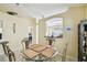Dining area featuring a glass round table and kitchen pass-through to an adjoining room at 8133 Canterbury Lake Blvd, Tampa, FL 33619