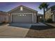 Charming single Gathering home with a two car garage, gray siding, and palm tree in the front yard at 8133 Canterbury Lake Blvd, Tampa, FL 33619