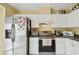 Well-lit kitchen featuring stainless steel appliances, white cabinets and a tiled floor at 8133 Canterbury Lake Blvd, Tampa, FL 33619