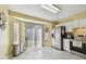 Galley kitchen features white cabinets, stainless steel appliances, gray countertops and light yellow walls at 8133 Canterbury Lake Blvd, Tampa, FL 33619