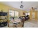Living room and dining area featuring a round dining table and dark brown leather couch at 8133 Canterbury Lake Blvd, Tampa, FL 33619