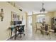 Comfortable living room with desk setup and a dining area that features a round glass table at 8133 Canterbury Lake Blvd, Tampa, FL 33619