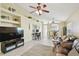 Open-concept living room featuring a brown leather sofa, a ceiling fan, and light yellow walls at 8133 Canterbury Lake Blvd, Tampa, FL 33619