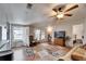 This naturally lit living room with a ceiling fan and unique rug provides a view of the bedroom and door to the patio at 8351 Fantasia Park Way, Riverview, FL 33578