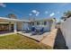 Cozy back patio includes an outdoor seating area and an attached carport for convenient parking at 921 57Th N Ave, St Petersburg, FL 33703