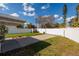 Fenced backyard provides privacy and security, complete with a driveway and grassy area at 921 57Th N Ave, St Petersburg, FL 33703