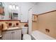 Bathroom with a tiled shower and tub, classic vanity, and decorative turtle art at 921 57Th N Ave, St Petersburg, FL 33703