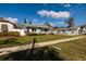 Charming single-story home boasts a well-manicured lawn and inviting curb appeal on a sunny day at 921 57Th N Ave, St Petersburg, FL 33703