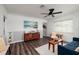 Cozy living room with hardwood floors, brick wall, and ample seating area at 921 57Th N Ave, St Petersburg, FL 33703