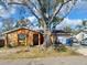 Charming single-story home featuring a stone facade, well-kept lawn, and mature trees providing shade at 10107 Lazy Creek Ct, Tampa, FL 33615