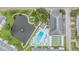 Aerial view of community amenities including a pond, swimming pool, and shuffleboard courts at 10116 Tulip N St # 10116, Pinellas Park, FL 33782