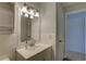 Bathroom with white vanity, ample lighting, tiled walls and doorway to the bedroom at 10116 Tulip N St # 10116, Pinellas Park, FL 33782