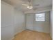 Well-lit bedroom with laminate flooring, white trim, and exterior access at 10116 Tulip N St # 10116, Pinellas Park, FL 33782