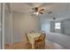 Charming dining area with hardwood flooring and view into living room at 10116 Tulip N St # 10116, Pinellas Park, FL 33782