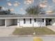 Charming single-story home with white exterior, front yard, and covered carport at 10116 Tulip N St # 10116, Pinellas Park, FL 33782