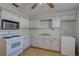 Efficient kitchen with white appliances, ample counter space, and linoleum flooring at 10116 Tulip N St # 10116, Pinellas Park, FL 33782