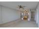 Open-concept layout with views into dining area and neutral carpeting at 10116 Tulip N St # 10116, Pinellas Park, FL 33782