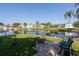 Serene community pond with a fountain, green lawns and walkways along the perimeter at 10116 Tulip N St # 10116, Pinellas Park, FL 33782