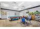 Cozy recreation room with a pool table, card table, bulletin board and comfortable seating at 10116 Tulip N St # 10116, Pinellas Park, FL 33782