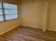 Cozy bedroom featuring wood-look floors, panelling and a window with blinds at 11200 102Nd Ave # 125, Seminole, FL 33778