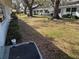 Well-maintained community lawn, partially shaded by mature oak trees, with nearby residential buildings at 11200 102Nd Ave # 125, Seminole, FL 33778