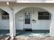Welcoming front door with a hanging plant, complemented by windows on either side at 11200 102Nd Ave # 125, Seminole, FL 33778
