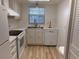 Well-lit kitchen featuring white appliances, laminate countertops, and a stainless steel faucet at 11200 102Nd Ave # 125, Seminole, FL 33778