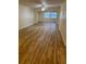 Bright living room featuring wood-look floors, a ceiling fan, and large windows at 11200 102Nd Ave # 125, Seminole, FL 33778