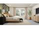 Bright bedroom with a stylish bed, decorative lamps, an accent chair, and neutral wall tones at 11542 E 71St Ter, Palmetto, FL 34221