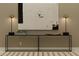 Modern console table decorated with lamps and a sleek, minimalist design against a neutral wall at 11542 E 71St Ter, Palmetto, FL 34221