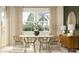 Chic dining room with an oval table, stylish chairs, and large windows offering a scenic view at 11542 E 71St Ter, Palmetto, FL 34221