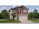 Two-story home with a two-car garage, well-manicured lawn and colorful, eye-catching, neutral paint scheme at 11542 E 71St Ter, Palmetto, FL 34221