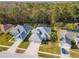 Neighborhood aerial showcases the home's manicured lot, three-car garage, and close proximity to neighbors at 12545 Leatherleaf Dr, Tampa, FL 33626